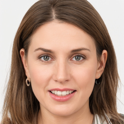 Joyful white young-adult female with long  brown hair and grey eyes