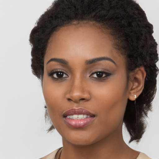 Joyful black young-adult female with long  brown hair and brown eyes