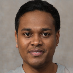 Joyful black young-adult male with short  black hair and brown eyes