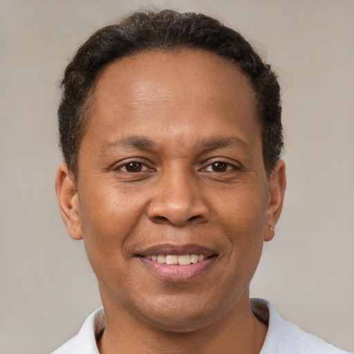 Joyful black adult male with short  brown hair and brown eyes
