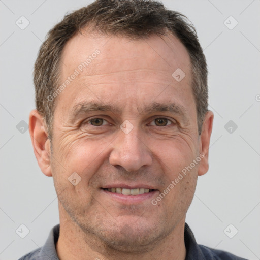 Joyful white adult male with short  brown hair and brown eyes