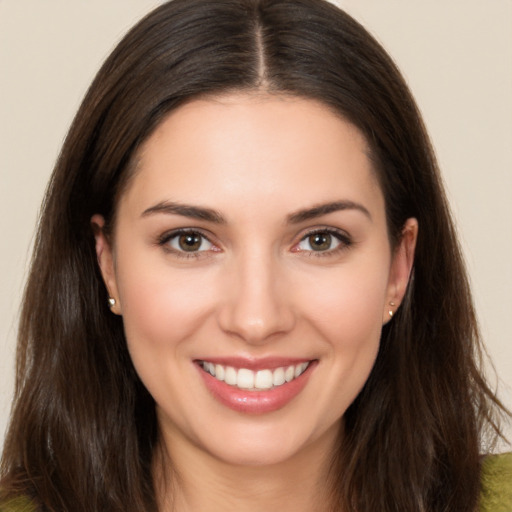 Joyful white young-adult female with long  brown hair and brown eyes