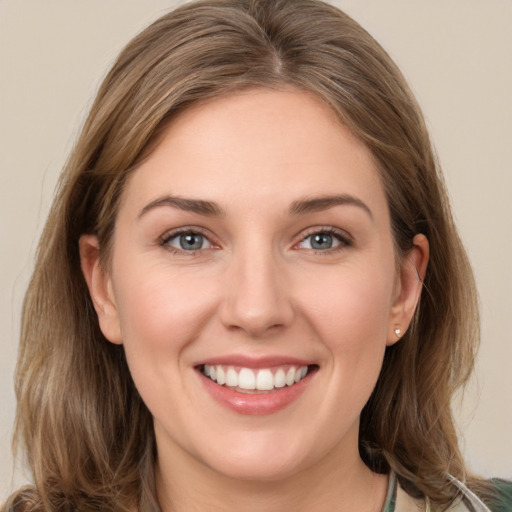 Joyful white young-adult female with medium  brown hair and grey eyes