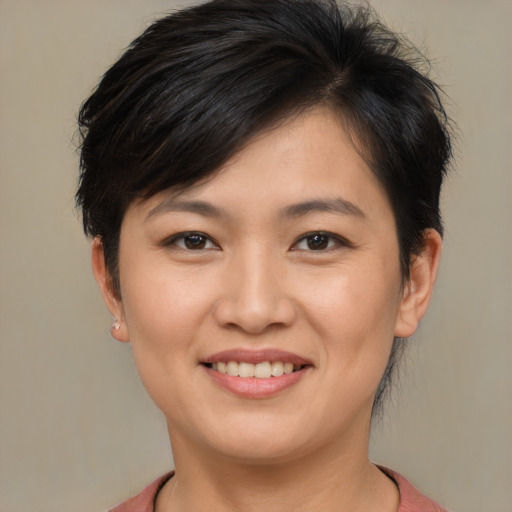 Joyful asian young-adult female with short  brown hair and brown eyes