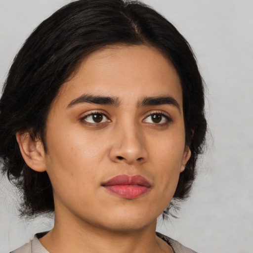 Neutral latino young-adult female with medium  brown hair and brown eyes