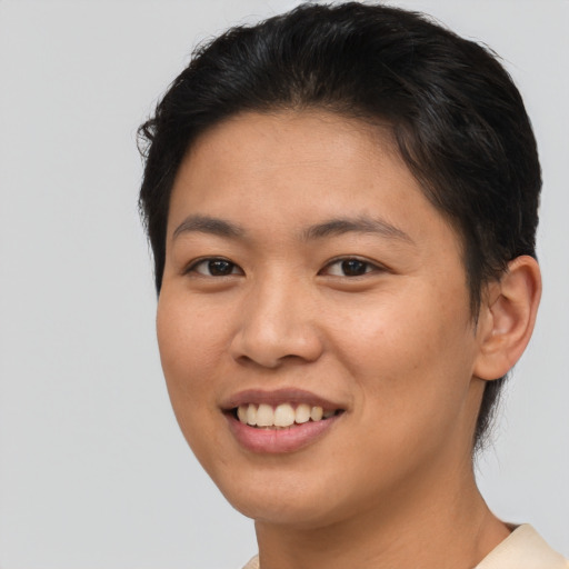 Joyful asian young-adult female with short  brown hair and brown eyes