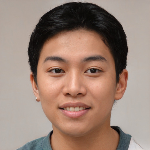 Joyful asian young-adult male with short  black hair and brown eyes
