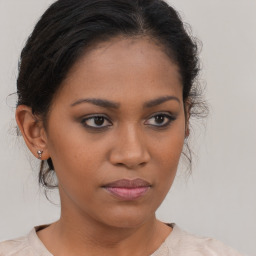 Joyful latino young-adult female with medium  brown hair and brown eyes