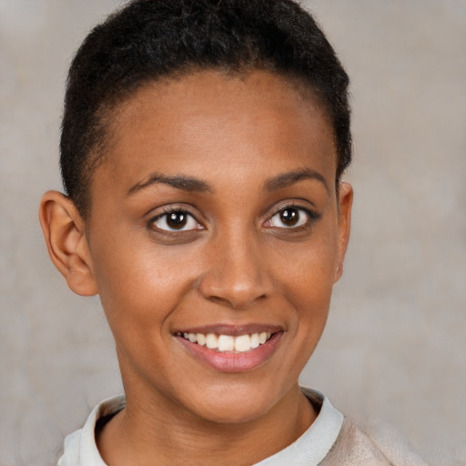 Joyful black young-adult female with short  brown hair and brown eyes