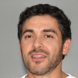 Joyful white adult male with short  black hair and brown eyes