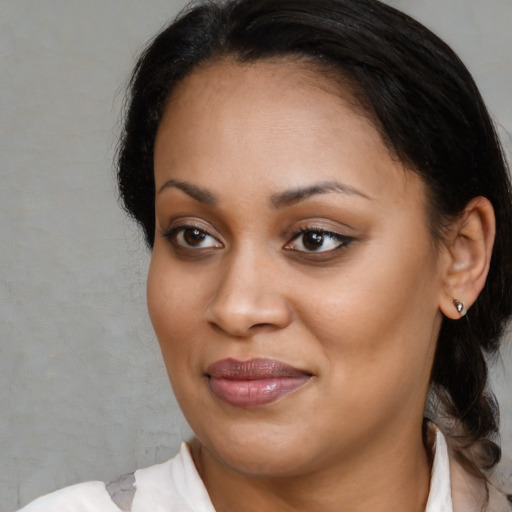 Joyful black young-adult female with medium  brown hair and brown eyes