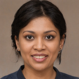 Joyful latino young-adult female with medium  brown hair and brown eyes