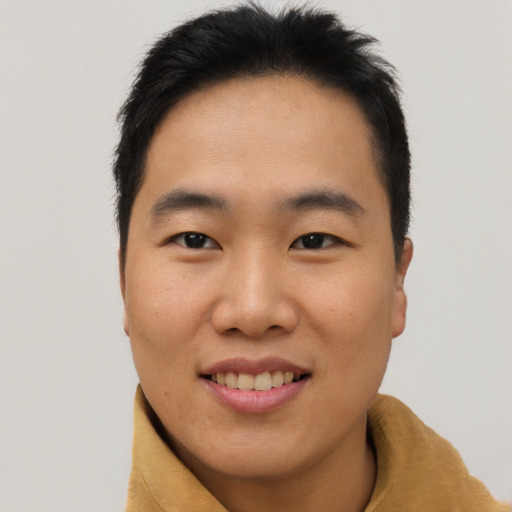 Joyful asian young-adult male with short  brown hair and brown eyes