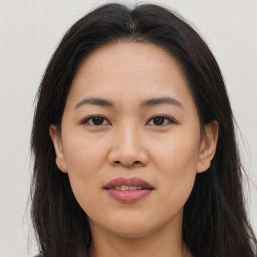 Joyful asian young-adult female with long  brown hair and brown eyes