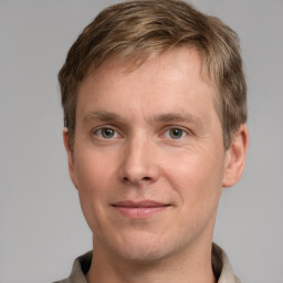 Joyful white adult male with short  brown hair and grey eyes