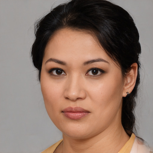 Joyful asian young-adult female with medium  brown hair and brown eyes