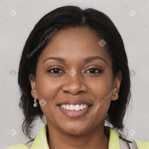 Joyful black young-adult female with medium  brown hair and brown eyes