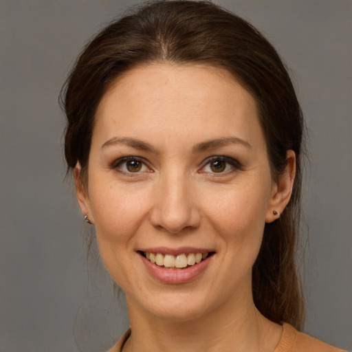 Joyful white young-adult female with medium  brown hair and grey eyes