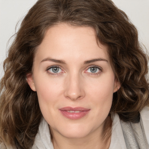 Joyful white young-adult female with medium  brown hair and green eyes