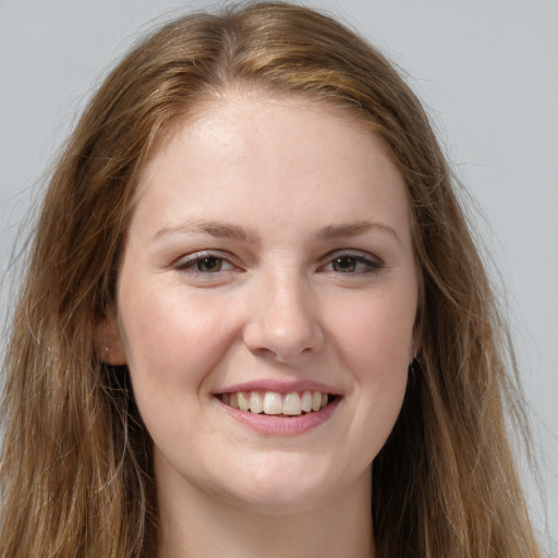 Joyful white young-adult female with long  brown hair and grey eyes