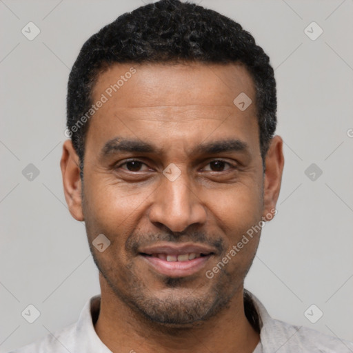 Joyful latino adult male with short  black hair and brown eyes