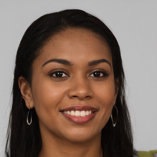 Joyful latino young-adult female with long  brown hair and brown eyes