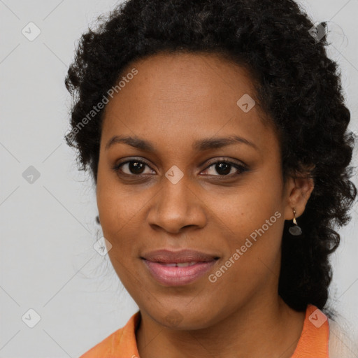 Joyful black young-adult female with long  brown hair and brown eyes