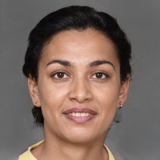 Joyful latino adult female with short  brown hair and brown eyes