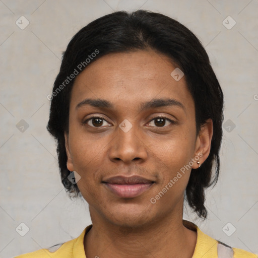 Joyful black young-adult female with short  black hair and brown eyes