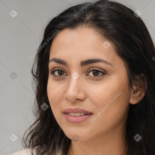 Joyful latino young-adult female with long  brown hair and brown eyes