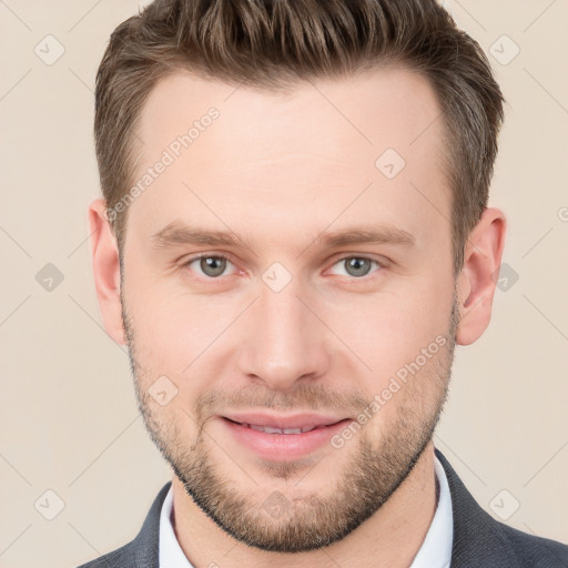 Joyful white young-adult male with short  brown hair and grey eyes