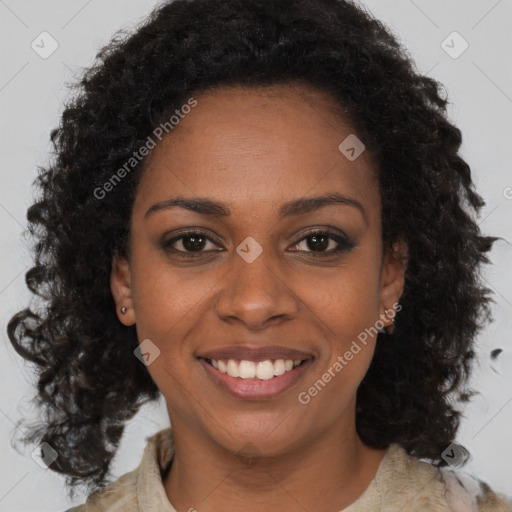 Joyful black young-adult female with long  brown hair and brown eyes