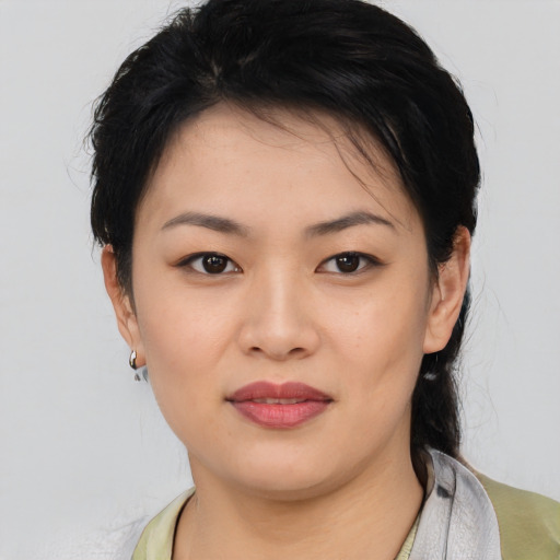 Joyful asian young-adult female with medium  black hair and brown eyes