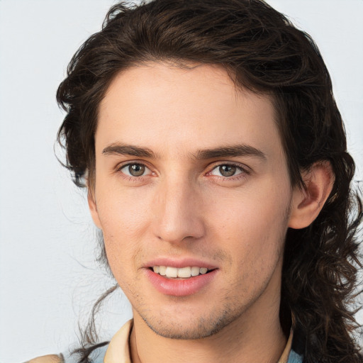 Joyful white young-adult male with medium  brown hair and brown eyes