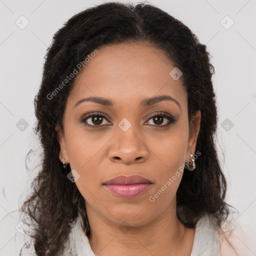 Joyful black young-adult female with long  brown hair and brown eyes