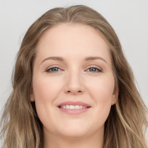 Joyful white young-adult female with long  brown hair and grey eyes