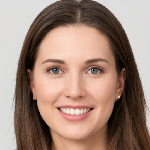 Joyful white young-adult female with long  brown hair and grey eyes