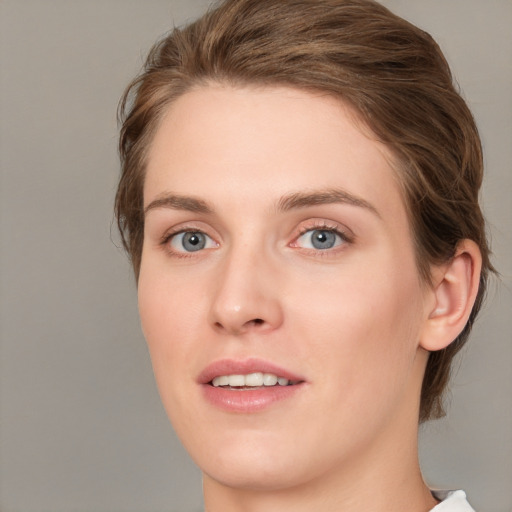 Joyful white young-adult female with medium  brown hair and green eyes