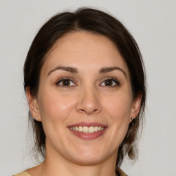 Joyful white adult female with medium  brown hair and brown eyes