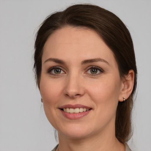 Joyful white young-adult female with medium  brown hair and brown eyes