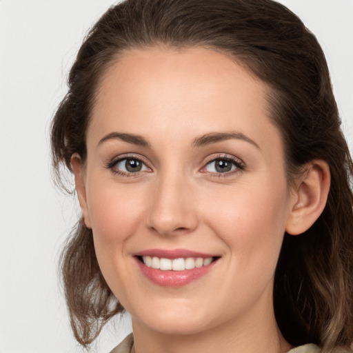 Joyful white young-adult female with long  brown hair and grey eyes