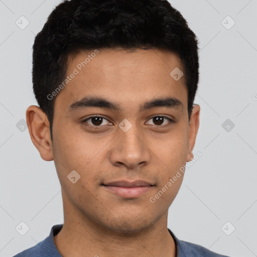 Joyful latino young-adult male with short  brown hair and brown eyes