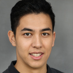 Joyful latino young-adult male with short  brown hair and brown eyes