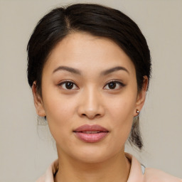 Joyful asian young-adult female with medium  brown hair and brown eyes