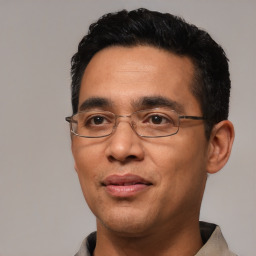 Joyful white adult male with short  black hair and brown eyes