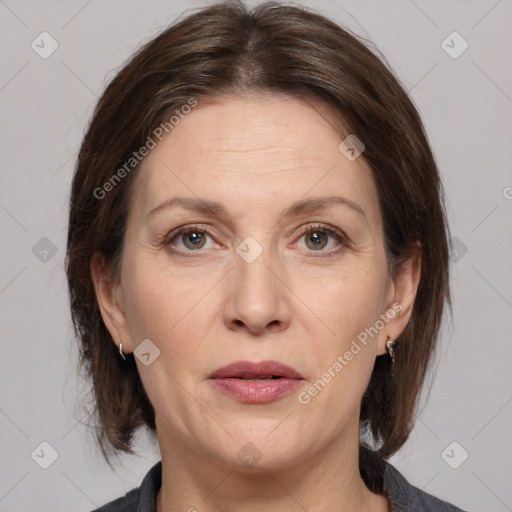 Joyful white adult female with medium  brown hair and grey eyes