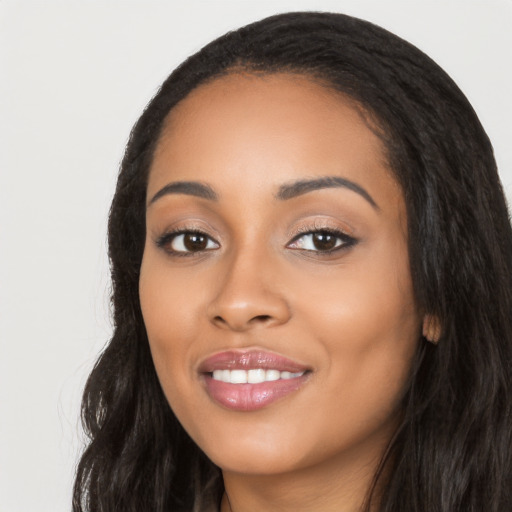 Joyful latino young-adult female with long  black hair and brown eyes