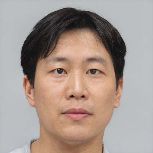 Neutral asian adult male with short  black hair and brown eyes