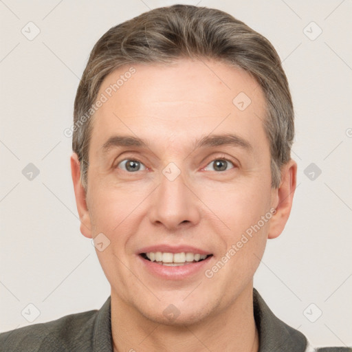 Joyful white adult male with short  brown hair and grey eyes