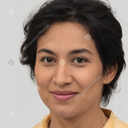 Joyful latino adult female with medium  brown hair and brown eyes